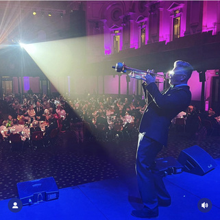 Pauli Wheeler on stage at Sydney Town Hall with live trumpet